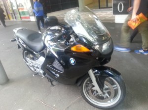 A motorbike on the sidewalk